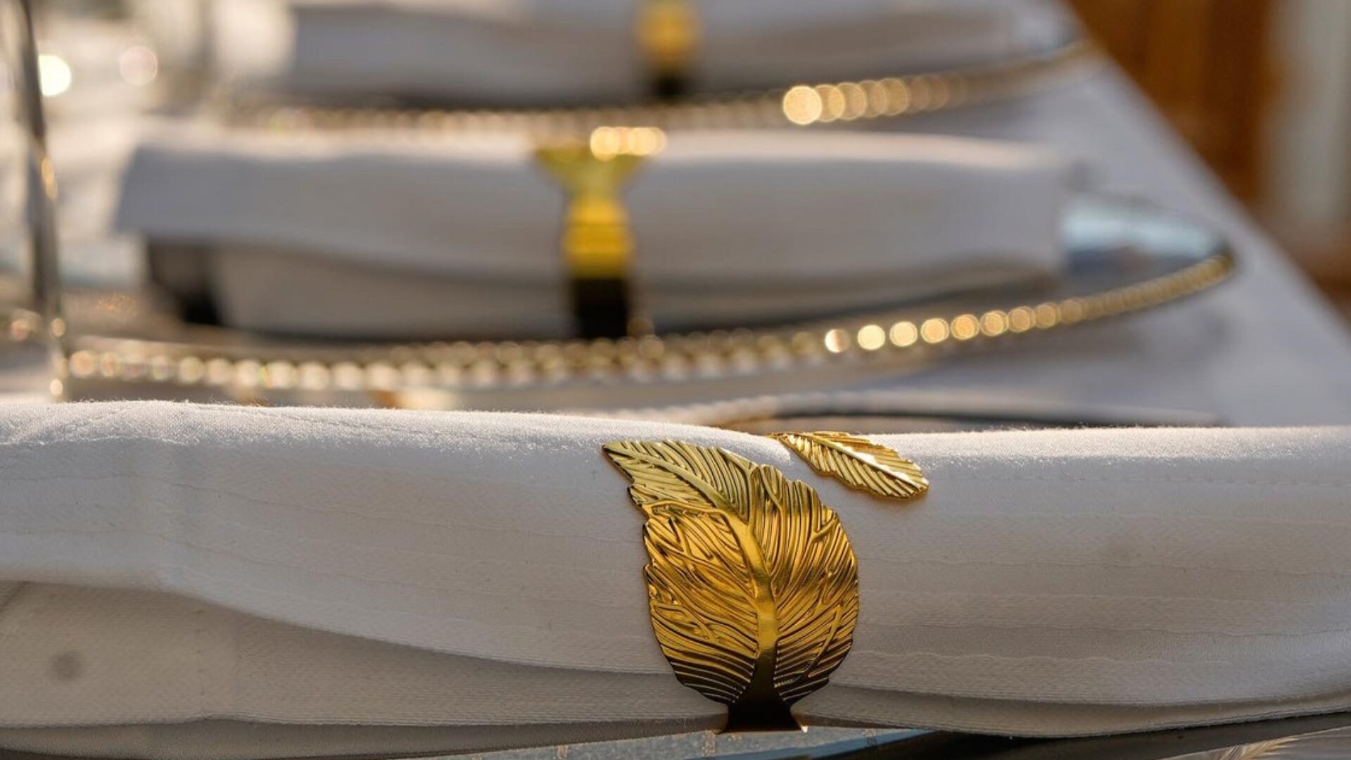 Gold leaf detail on a napkin at a gala dinner table setting