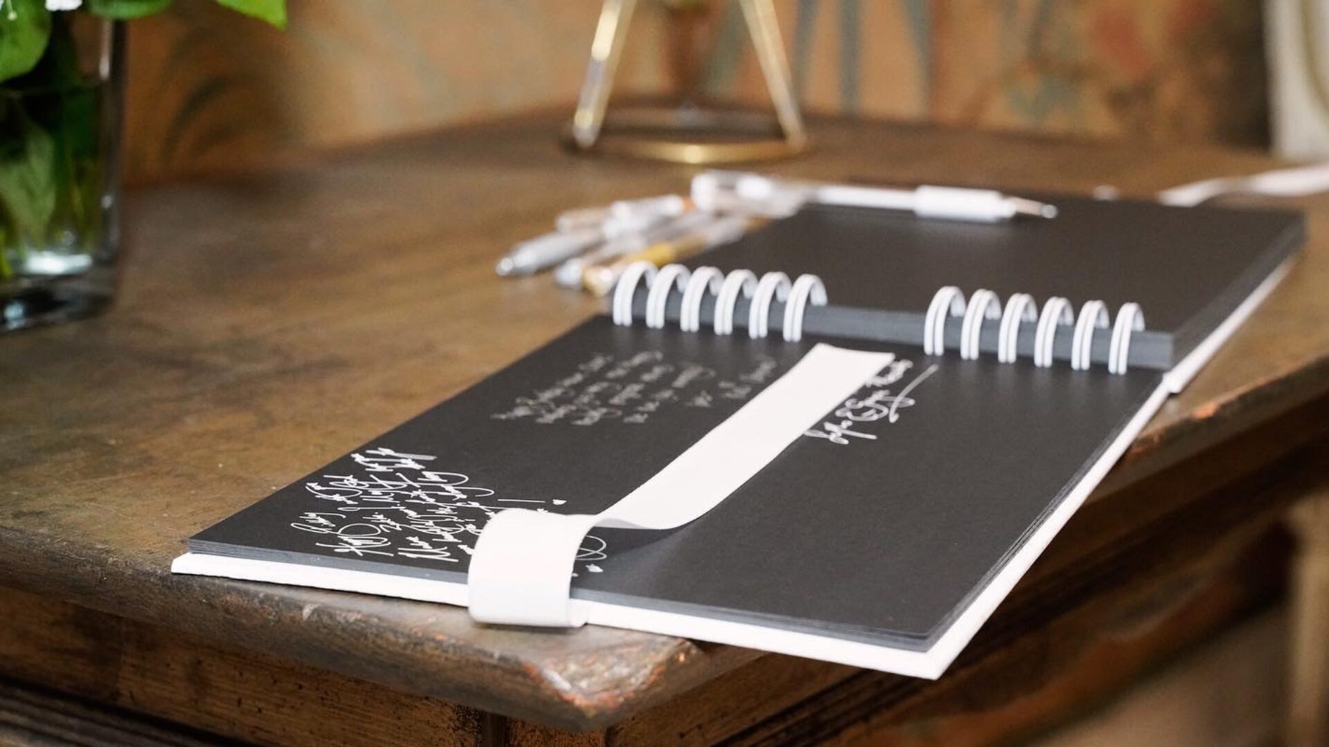 Guest book and pens set out on a welcome table at a corporate event