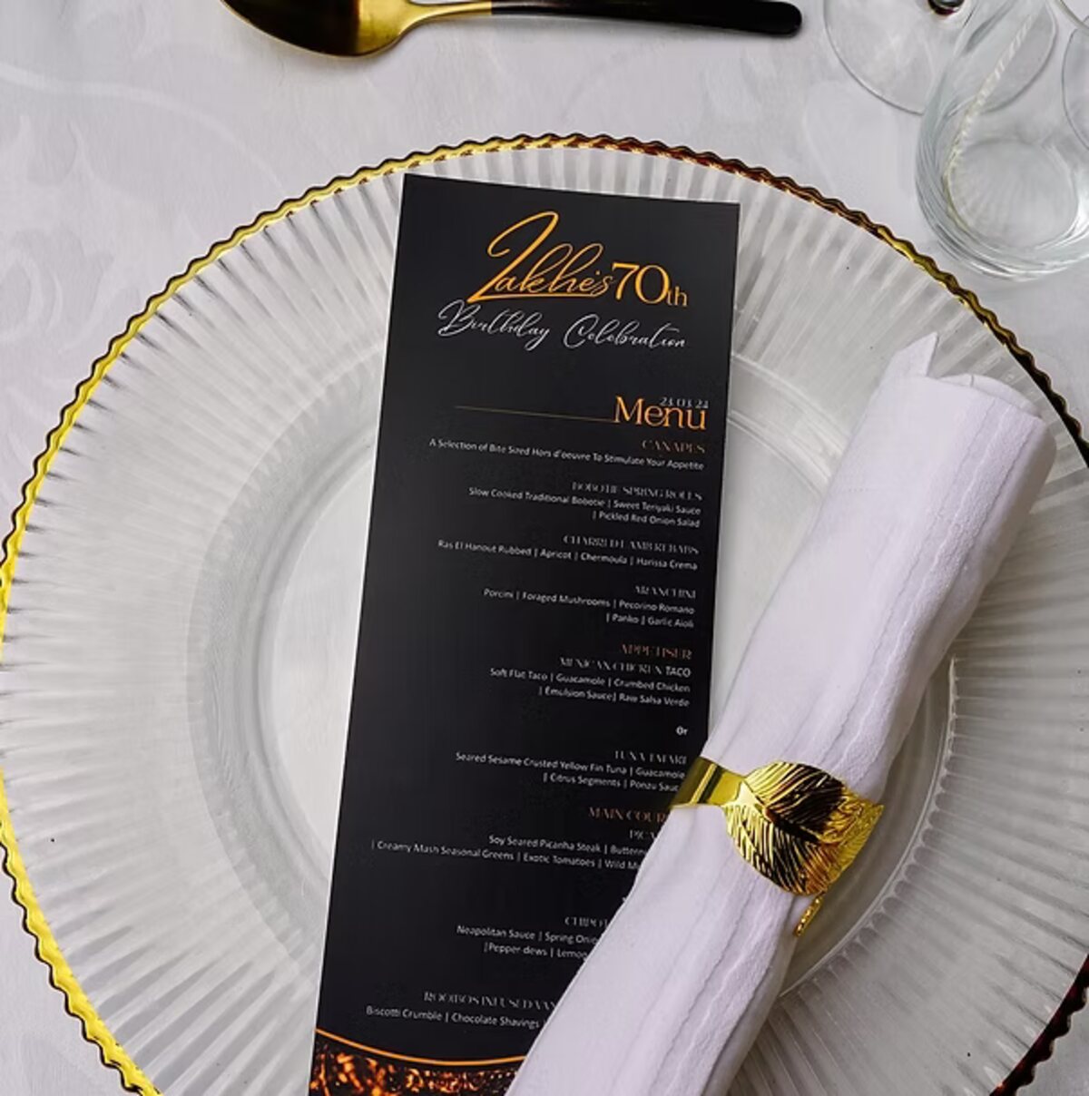 Printed menu card on a gold rimmed charger plate at a styled dinner